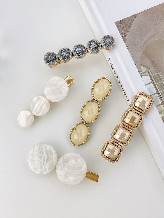 5 harpingloj kun ronda ornamaĵo