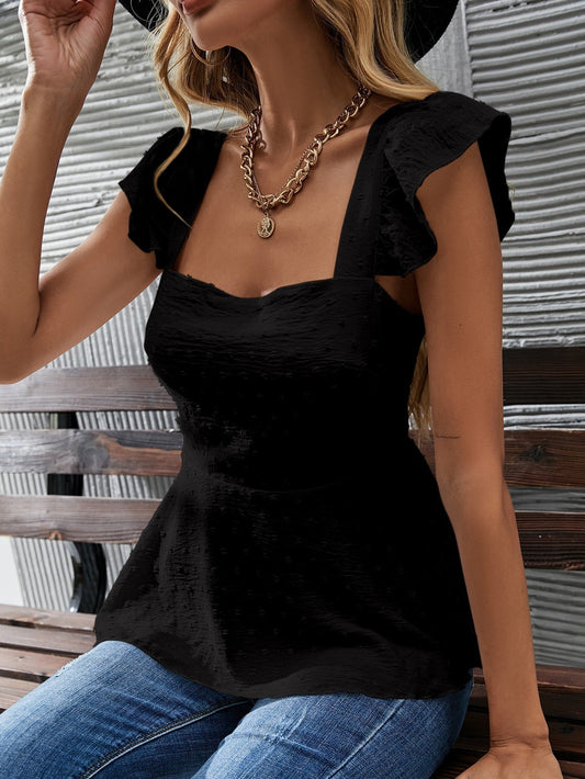 Supraĵo kun punktoj, papiliaj manikoj kaj volanoj